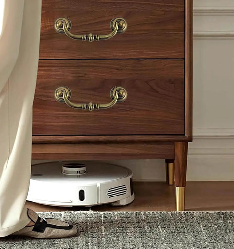 Antique Bronze Drawer Pulls Six Pack With Three And A Half Inch Hole Centers For A Retro Dresser Makeover Vintage Vibes Zinc Alloy Drop Bail Pulls For Kitchen Cabinets Cupboards And Desk Drawers RiseDirectly shown on wooden dresser with robot vacuum underneath.