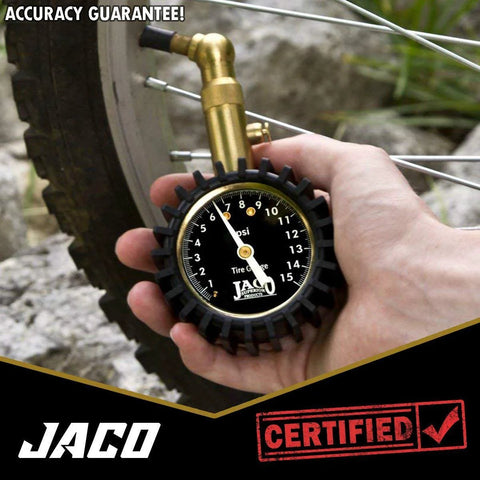 JACO Elite Low Pressure Tire Gauge on bicycle tire valve; brass nozzle, black dial, 0–15 psi.