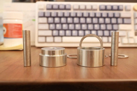 Coin Ring Puncher and Spacer Set for Jewelry Making with Six Spacer Rings in Inner Diameters of 1.362, 1.276, 1.228 on desk.