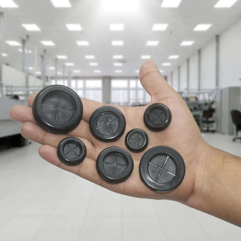 Hand holding 52 Piece Rubber Grommets Kit With Firewall Hole Plugs In Six Hole Sizes for wire protection and automotive repair