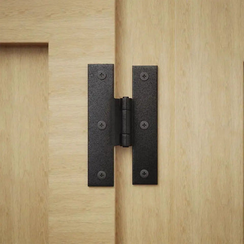 3.5 Inch Black Wrought Iron H Hinge With 1/4 Inch Offset For Kitchen Cabinets installed on light wood surface