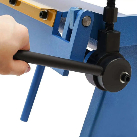 Close-up of hand operating 24 Inch Pan And Box Brake Sheet Metal Hand Tool With Removable Fingers For Precise Bends in blue