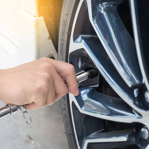 Tallew silver dual-head tire pressure gauge in use on car tire valve; 10-150 PSI, 1-10 Bar range.