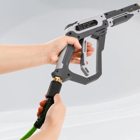 PWACCS pressure washer spray gun with gray/black body and brass connector attached to a green hose