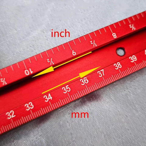 Close-up of red scale in inches and millimeters on Adjustable Router Jig For Cutting Boards And Grooves, Square Template Guide With A 23.6 By 23.6 Inch Frame, Precise, Easy To Use Woodworking Jig For Perfect Grooves In Red.