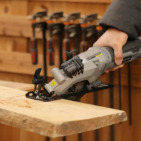 Person using Powerful Corded Four Amp Circular Saw With Laser Guide And Bevel Cuts, 3500 RPM, Four And A Half Inch 24T TCT Blades