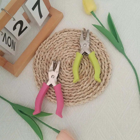 Soft Grip Hole Punch Set with pink and green handles displayed on a woven mat, featuring 1/4 inch and 1/8 inch sizes for scrapbooks.
