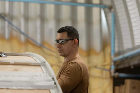 Man wearing Tacana ANSI Z87.1 Safety Glasses for Men With Anti Fog Lenses Built For The Daily Grind in a workshop setting.