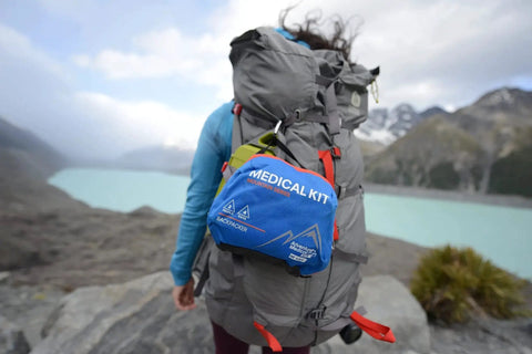 Backpacker First Aid Kit for Outdoor Trails Expedition Grade Medical Kit for Two Adventurers Up To Four Days attached to a backpack