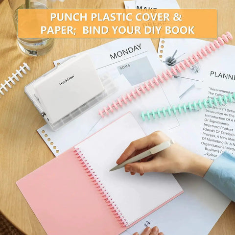 Person binding notebook with Handy Metal Hole Punch Binding Tool For Planners And Notebooks, multicolor rings visible