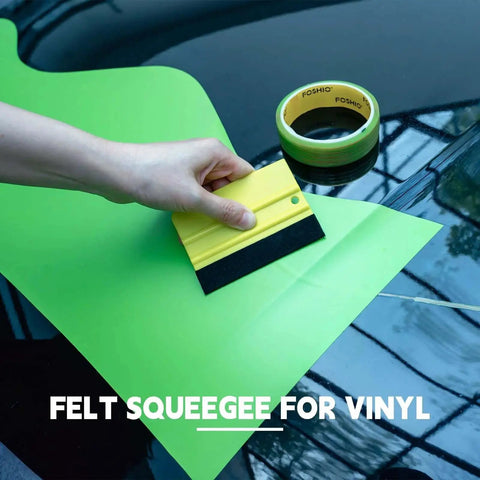 Hand using felt squeegee on green vinyl next to Vinyl Wrap Cutting Tape 50 Meter Roll With Felt Squeegee For Easy Contoured Cuts And Knifeless Tape Filament Ideal For Car Motorcycle Boat Graphics And Decals 164 Feet