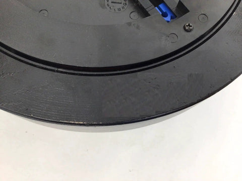 Hydra Fitness Exchange magnetic brake flywheel; black circular plate with blue connector.