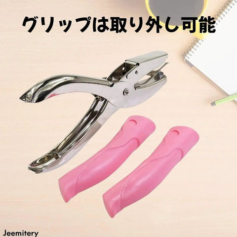 One Sixteenth Inch Circle Hole Punch Handheld Metal Punch With Soft Cushioned Grip For Tags Clothing Tickets Craft Projects No Mess No Fuss Scrap Cage For Easy Cardstock Punching showcased with detachable pink grips.