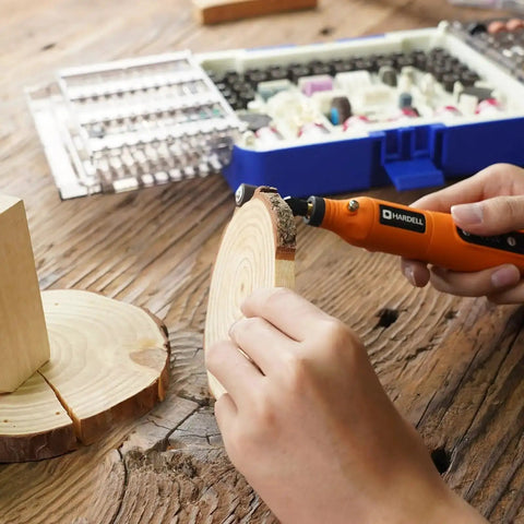 Person using rotary tool from Must-Have Rotary Tool Bits Kit For Dremel And Other Brands, 508-Piece Universal Set for wood carving