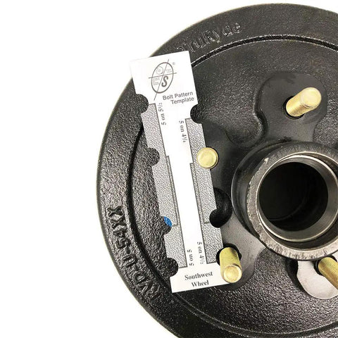 Southwest Wheel trailer hub close-up showing 5-on-4.5 bolt circle template and gold studs