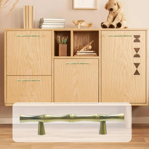 Bamboo Shape Zinc Alloy Drawer Pulls in Brushed Gold Finish 4.96 inch length displayed on a wooden cabinet, shown with 3 inch center to center hole distance.