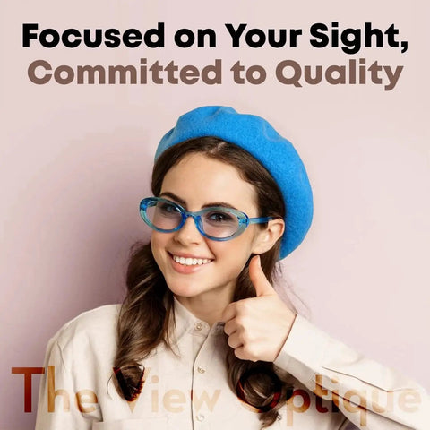 Woman wearing blue-framed glasses and blue beret against pink background, promoting Anti Reflective Safe Lens Cleaner Spray for Glasses Cameras and Screens