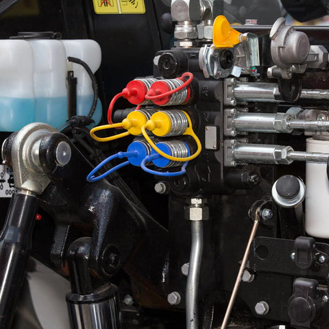 Tondiamo 10-set hydraulic dust caps and plugs on a valve block; color-coded red, yellow, blue for 1/2 in couplings