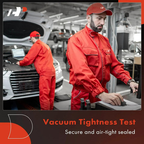Mechanics in red uniforms performing vacuum tightness test on car in workshop