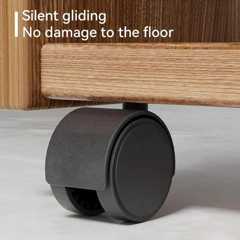 Smooth rolling black nylon caster installed on wooden furniture leg