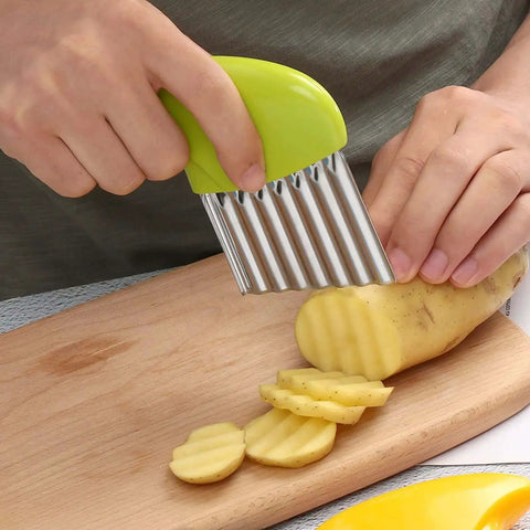 Crinkle Cutter Knife Set With Wavy Blades For Vegetables And Fries Includes 3 Potato Carrot Wave Cutters And A Slicing Fork 430 Stainless Steel With Ergonomic ABS Handle Kitchen Gadget in use slicing potato on cutting board.