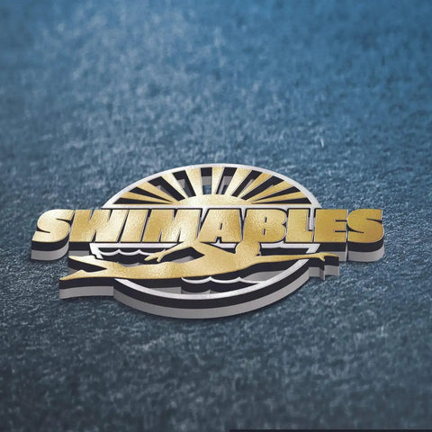 Metallic "Swimables" logo with swimmer and sun design on textured surface.