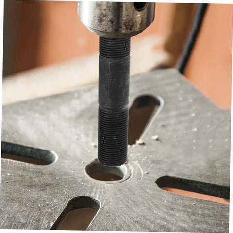 Close-up of hydraulic tool kit with punch driver and die set punching a hole in metal sheet for electrical conduit projects.