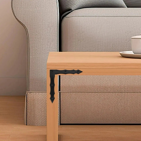 Decorative L Shaped Corner Brackets Set Of 10 In Rustic Black Finish installed on wooden table corner