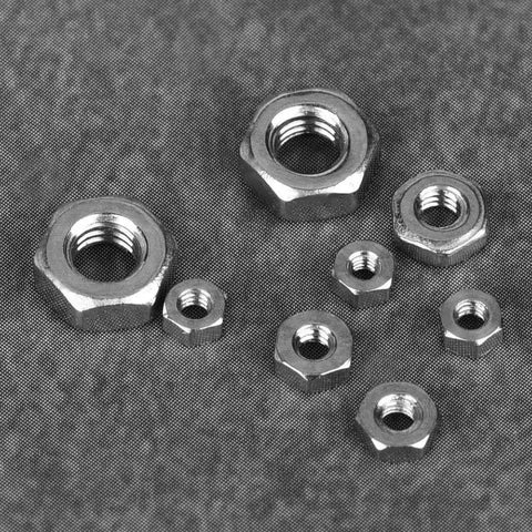 140 Piece Hex Nut Set In 304 Stainless Steel With M1 M1.2 M1.4 M1.6 M2 M2.5 M3 Sizes Seven Types Of Hex Nuts On Gray Surface