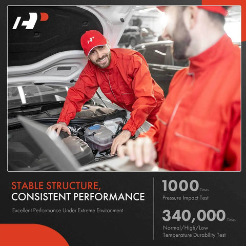 Two mechanics in red uniforms performing tests under car hood in a workshop setting.
