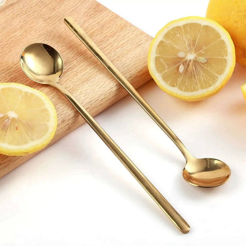 Gold Tone 6.7 Inch Long Handle Coffee And Tea Spoons Set Of 4 Stainless Steel Dope Stirring Spoons with lemons on a wooden board