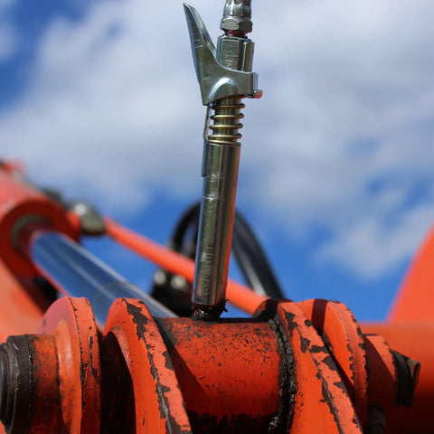 LockNLube XL grease gun coupler, silver metal, extended reach, universal fit on orange machinery