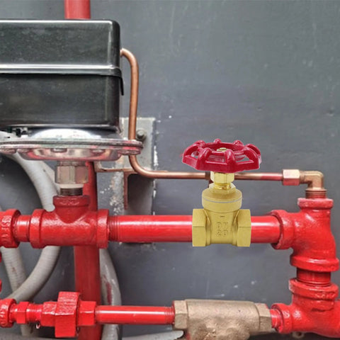 Brass 3/4 inch valve with red wheel handle on red piping, DN20 marking, for water lines