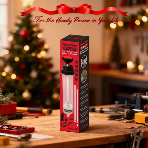 Box of 500cc Fluid Extractor And Oil Syringe With Leak Proof Dual Seal Pump on a wooden workshop table with holiday decor