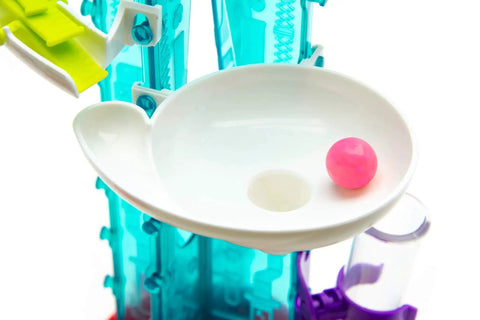 Thames and Kosmos Gumball Machine Maker toy, close-up view; pink gumball in white dish with teal frame
