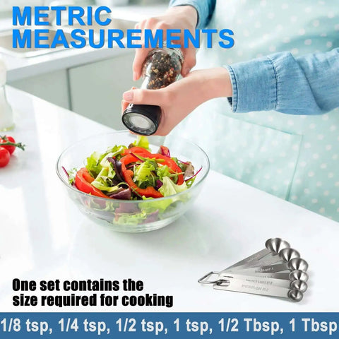 Person seasoning salad with Must Have Sturdy Stainless Steel Measuring Spoons Set Of 6 With Metric And US Measurements nearby
