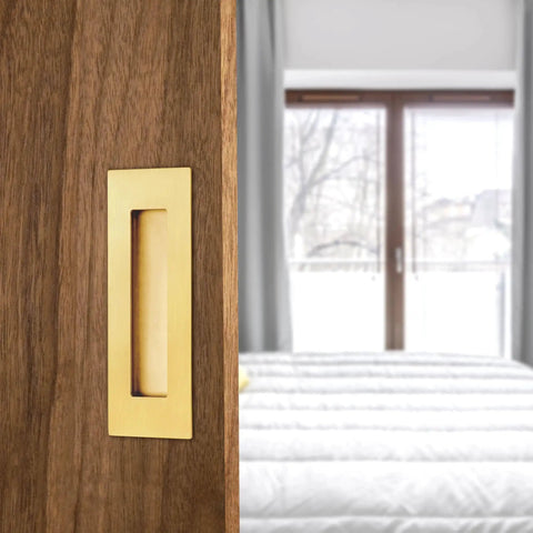 6 Inch Recessed Finger Flush Door Pulls For Pocket And Sliding Barn Doors In Brushed Gold Stainless Steel installed on wooden door