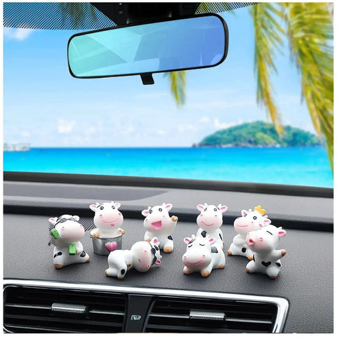 8 Pcs Cute Cow Car Dashboard Ornaments Set For Interior Decor displayed on a car dashboard with a scenic background view