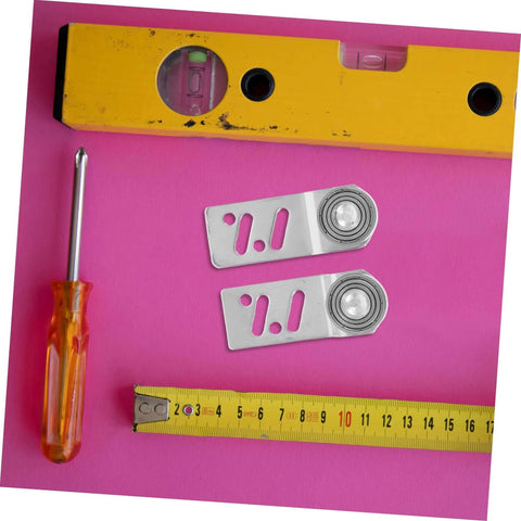 Beefy Stainless Steel Sliding Door Pulley Kit With Track Mounted Roller, screwdriver, measuring tape, and level on pink background