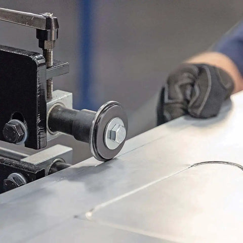 Close-up of Budget-Friendly 19 Inch Metal Bead Roller With Power Drive System in use, forming bead on metal panel.