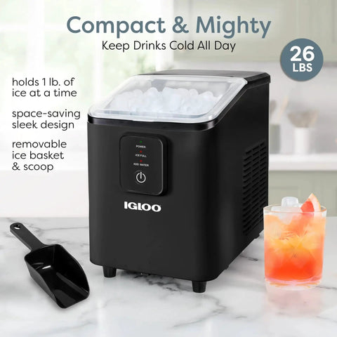 Compact Countertop Ice Maker 26 Lbs Per Day Fast Ice Includes Scoop And Basket on a kitchen counter next to a drink and scoop.