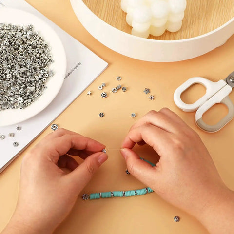 Hands crafting bracelet with Tibetan Silver Spacer Beads 1000 Pieces Metal Beads For Jewelry Making Bracelet And Necklace Craft Supplies