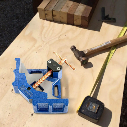 Heavy Duty Ductile Iron Welding Angle Clamp With 4.72 Inch Opening And 2.36 Inch Jaw Depth Powder Coated For Rust Resistance next to hammer and wood pieces.