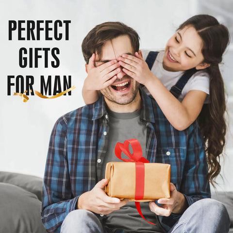 Girl covering man's eyes with hands while he holds a gift with a red ribbon, with text 'Perfect Gifts For Man' behind.