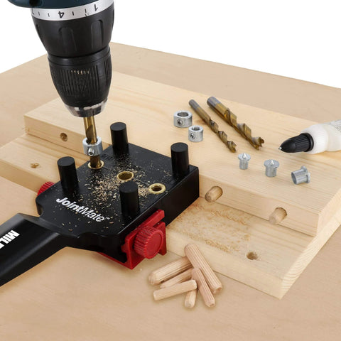 Self Centering Dowel Jig Kit For Woodworking in use with handheld jig, metal bushings, drill, dowels, and wood pieces for joints.