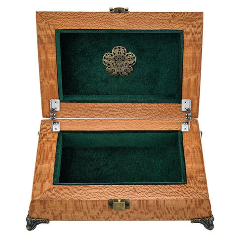 Open wooden jewelry box with green velvet lining and decorative metal clasp