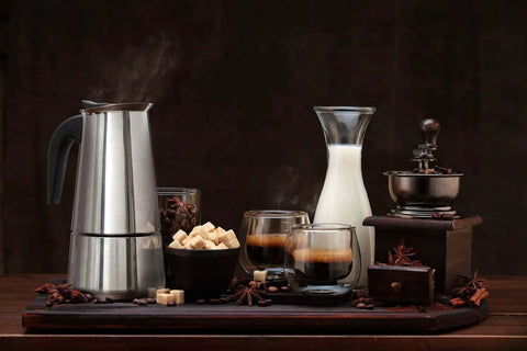 Stovetop Espresso Maker 9 Cup Moka Pot in Stainless Steel 450ml surrounded by coffee cups, milk, and sugar cubes on wooden tray.