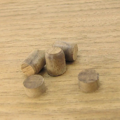Wooden plugs made with the Three Piece Tapered Plug Cutter Set For Woodworking, Includes 1/4, 3/8, And 1/2 Inch Cutters, grain matched.