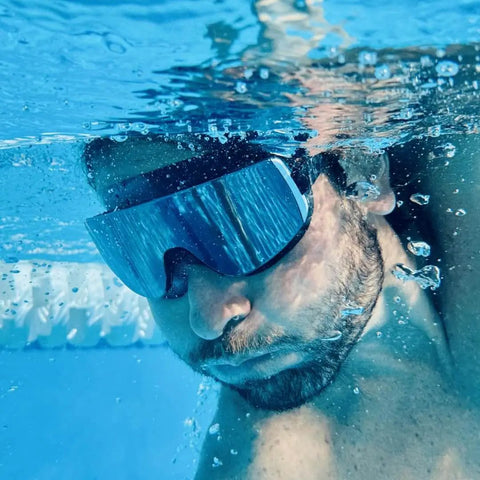 Underwater view of person wearing Frameless Ultralight Black Mirror Swim Goggles With VisiClear Nanotech Anti Fog Lens And 100 Percent UV Protection
