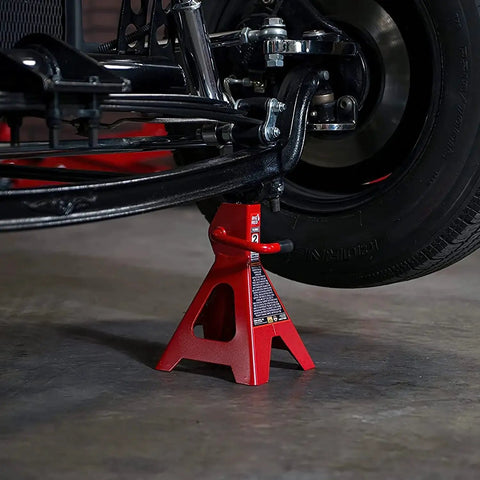 2 Ton Steel Car Jack Stands Pair 4000 Lb Capacity With Welded Frame supporting a vehicle tire